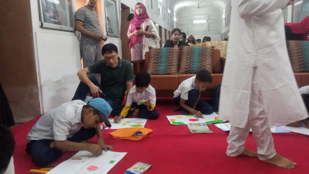 Watching a drawing competition in Bangladesh by a Singaporean tourist.